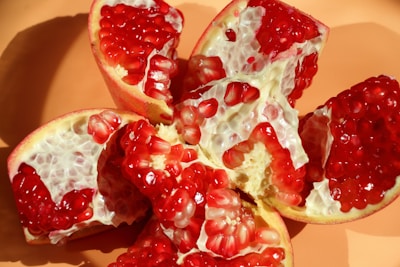 A pomegranate cut in half on a plate