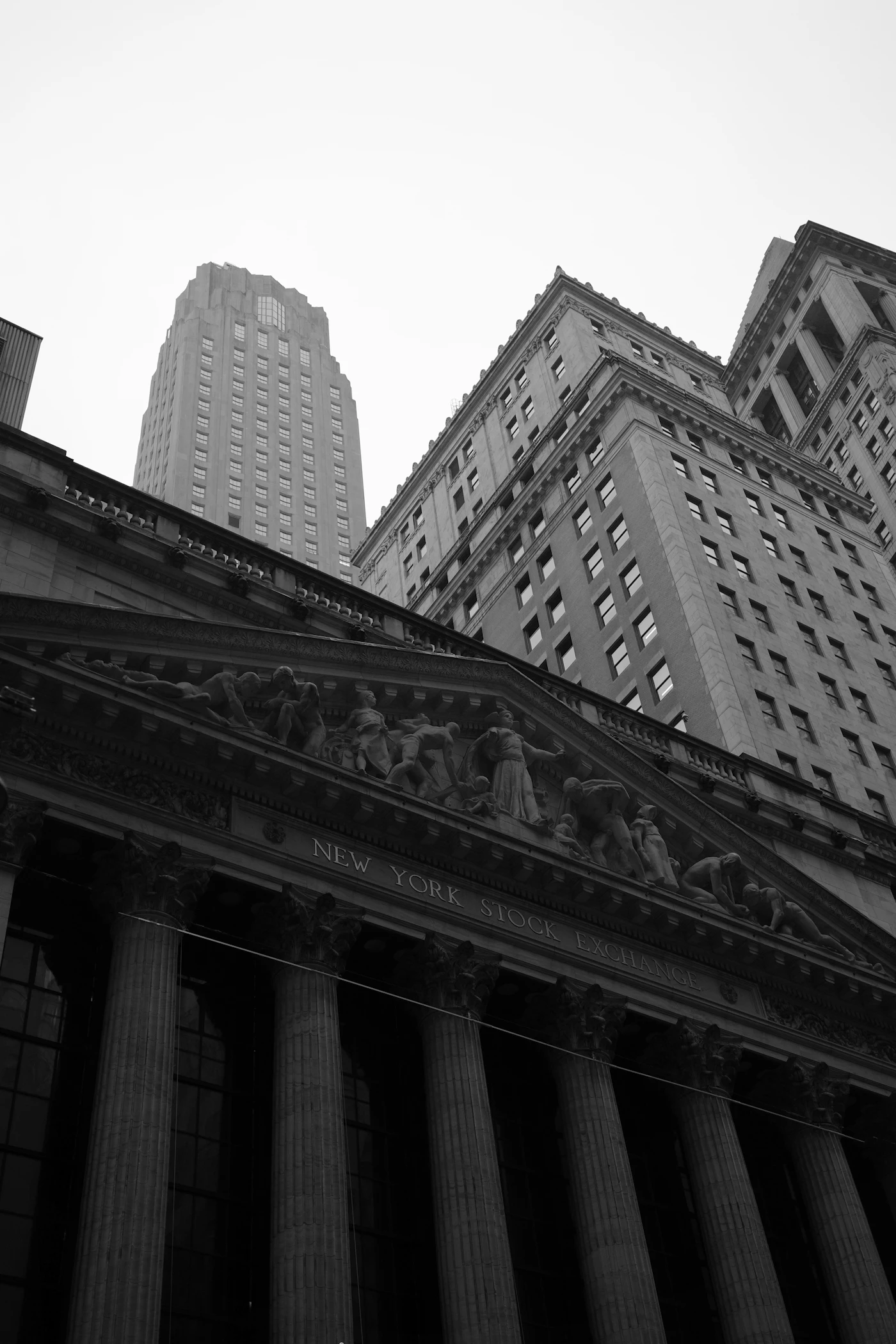 A black and white photo of the New York Stock Exchange building