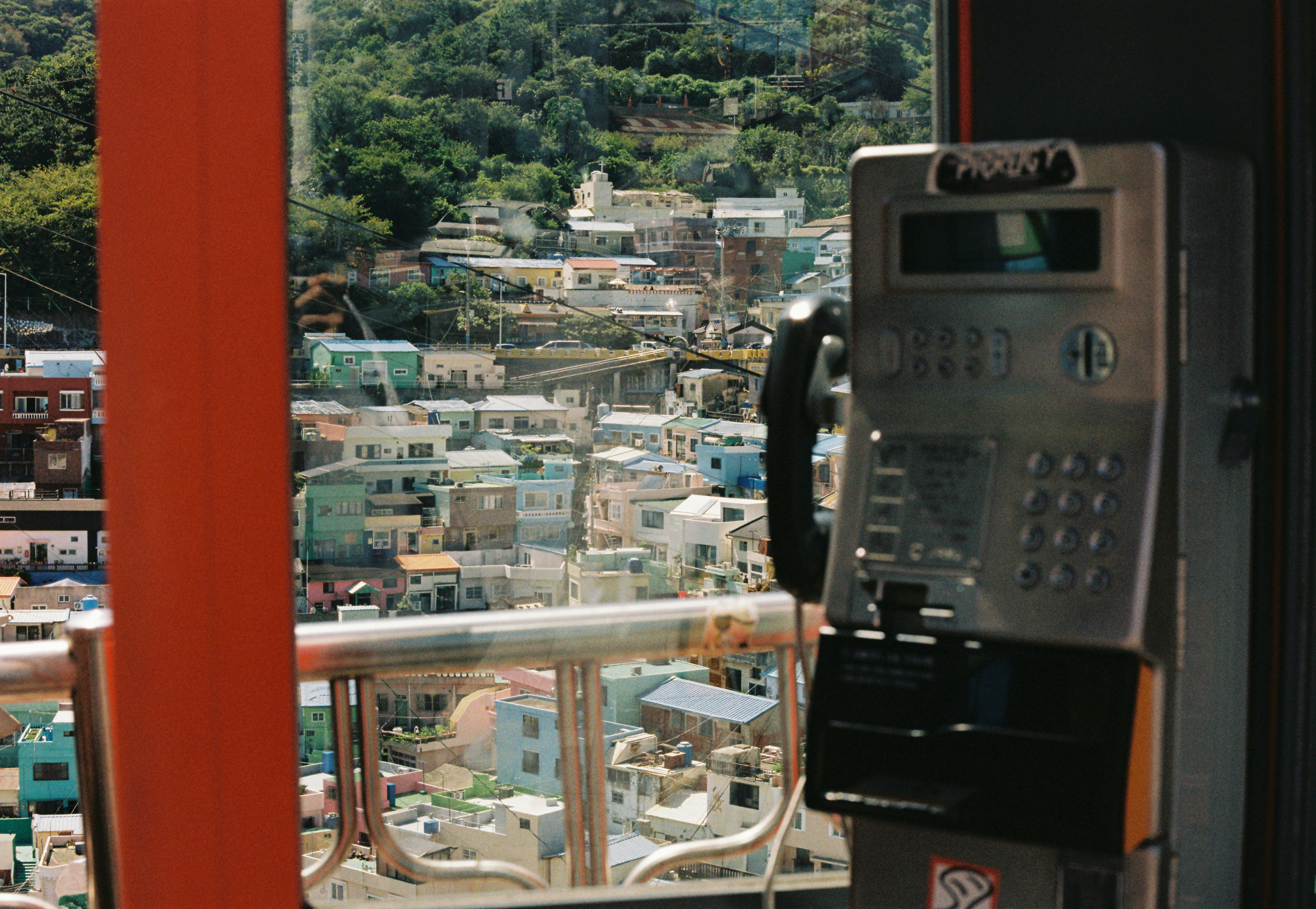 A phone booth with a view of a city