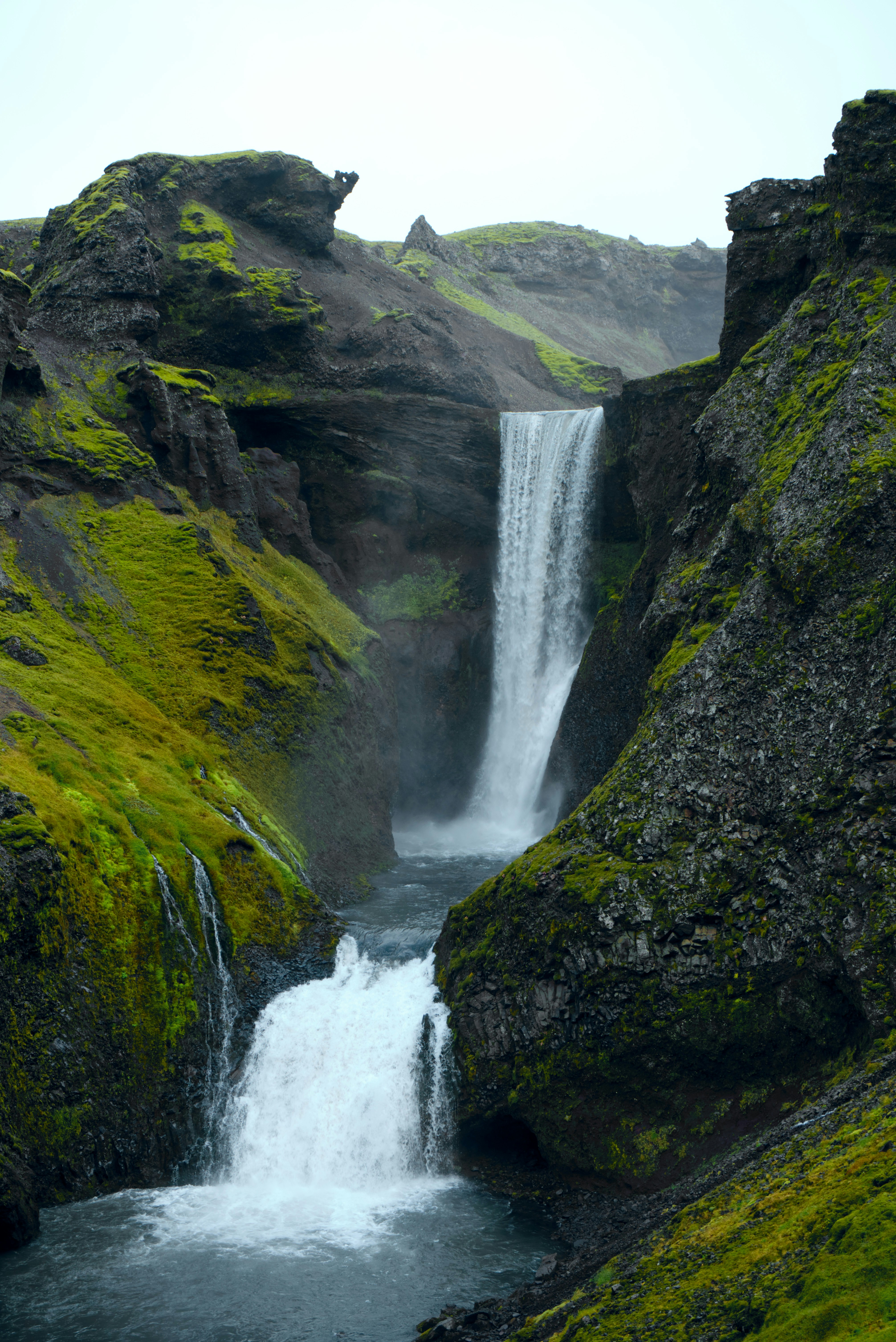 A waterfall with moss growing on the rocks