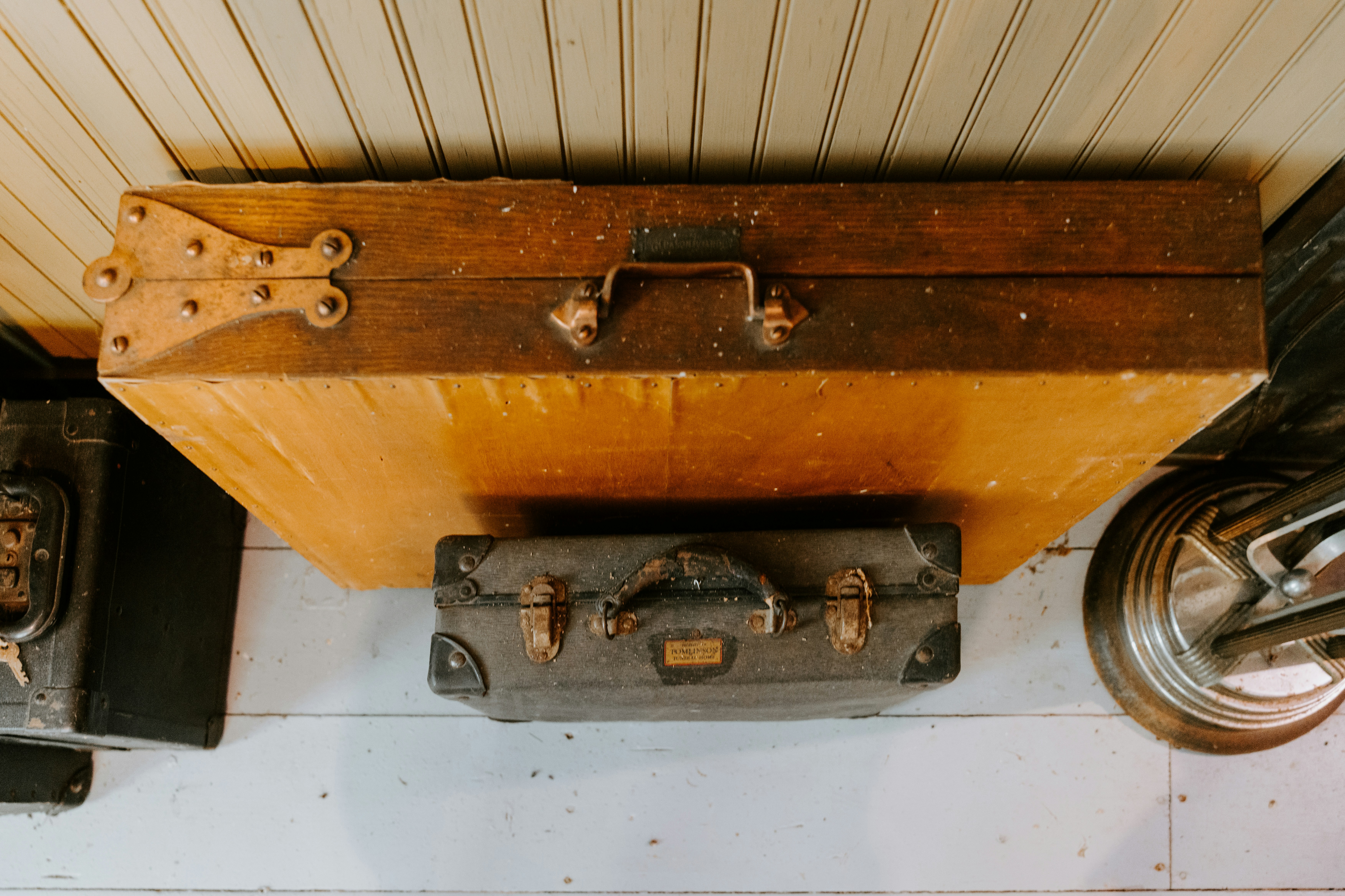 An old suitcase is sitting on the floor