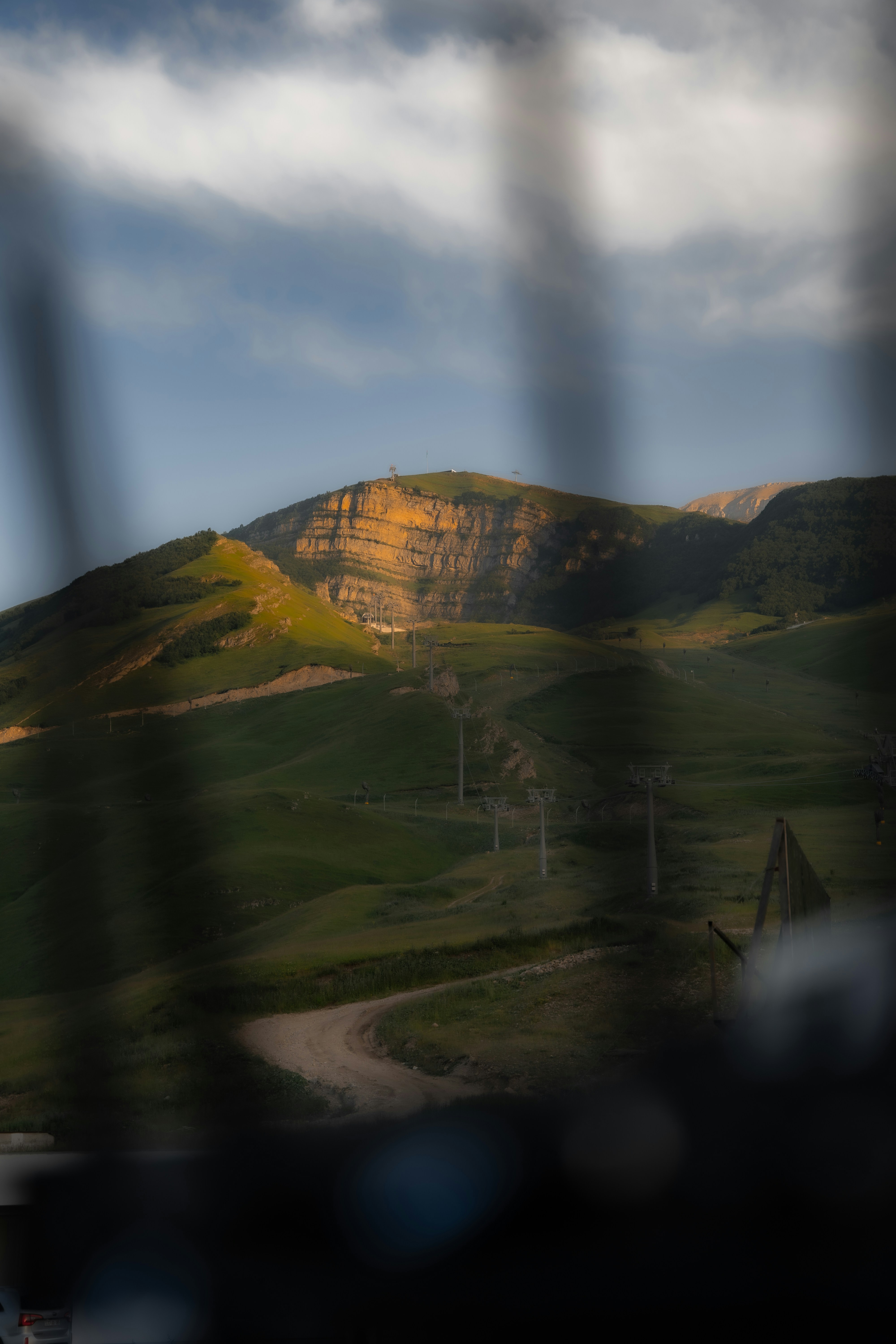 A view of a mountain range through a fence