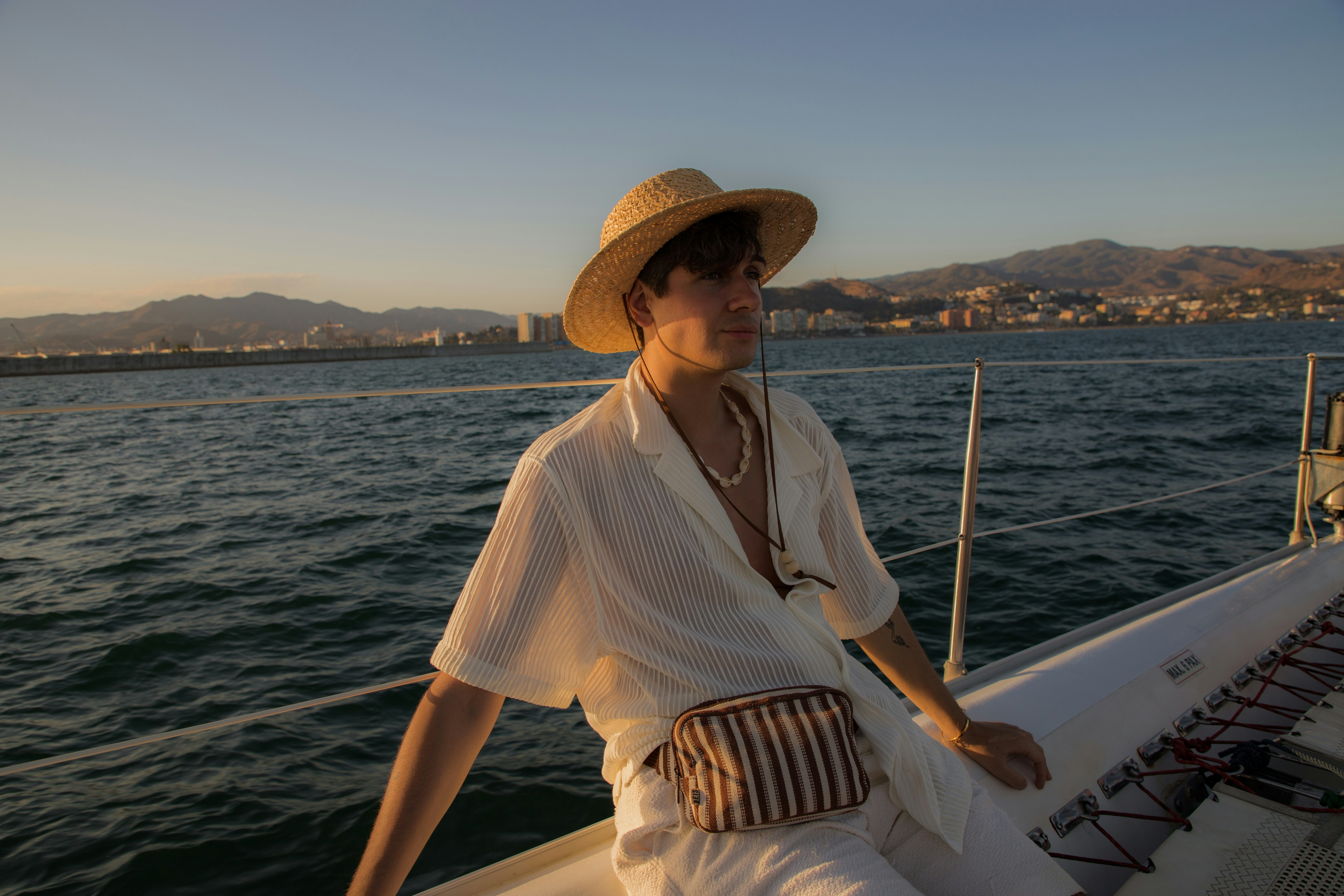 A woman in a hat is sitting on a boat