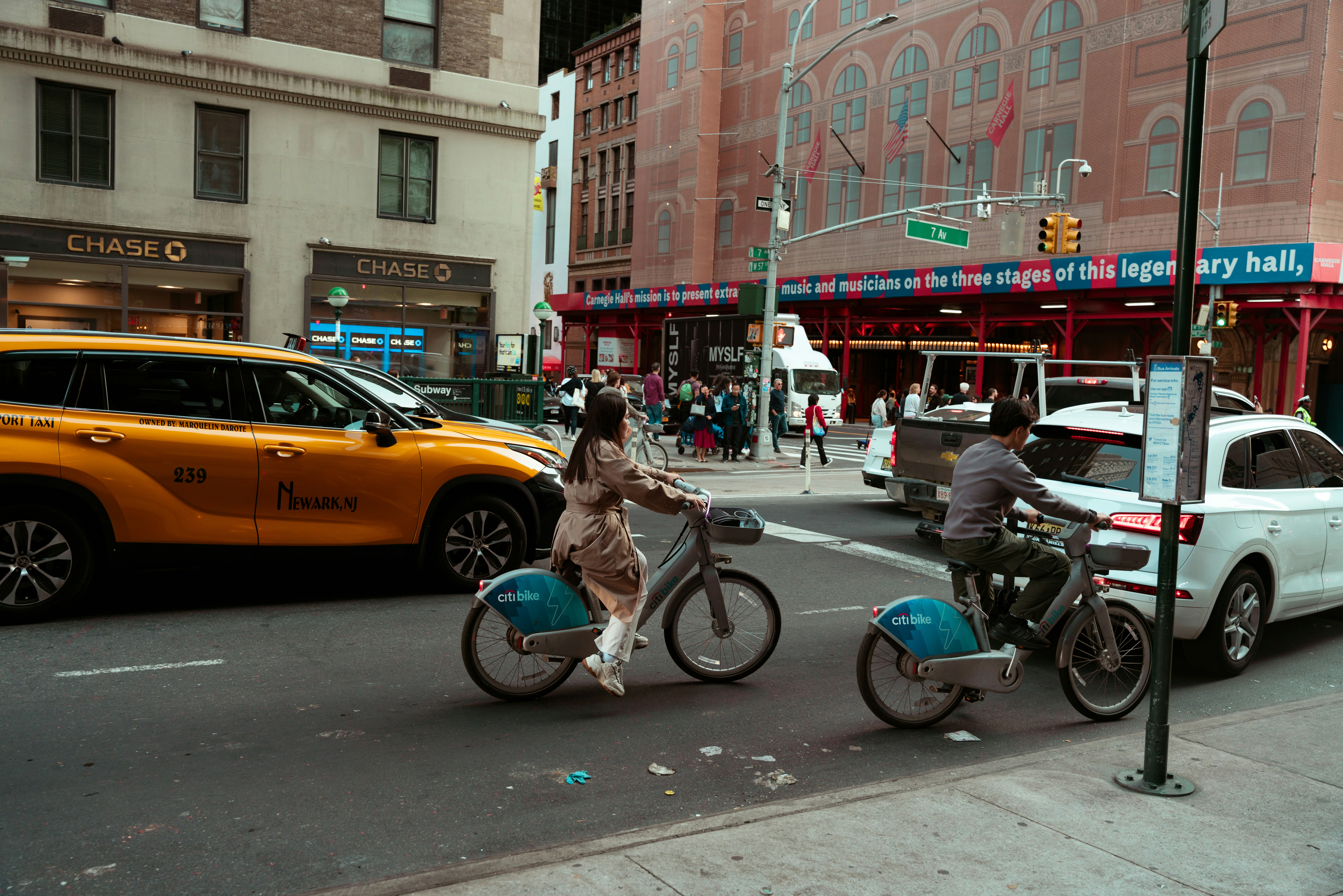 A couple of people riding bikes down a street