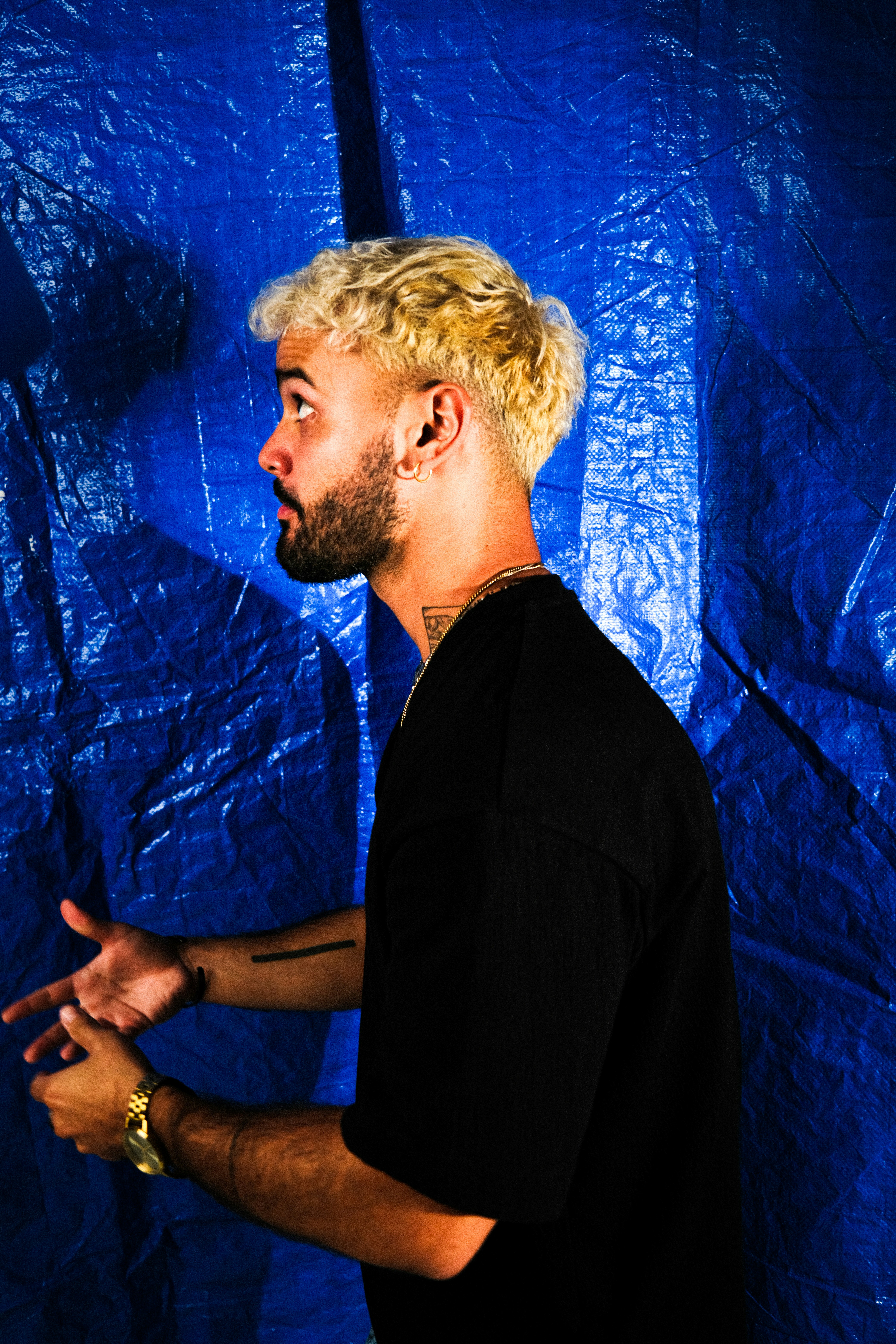 A man standing in front of a blue backdrop