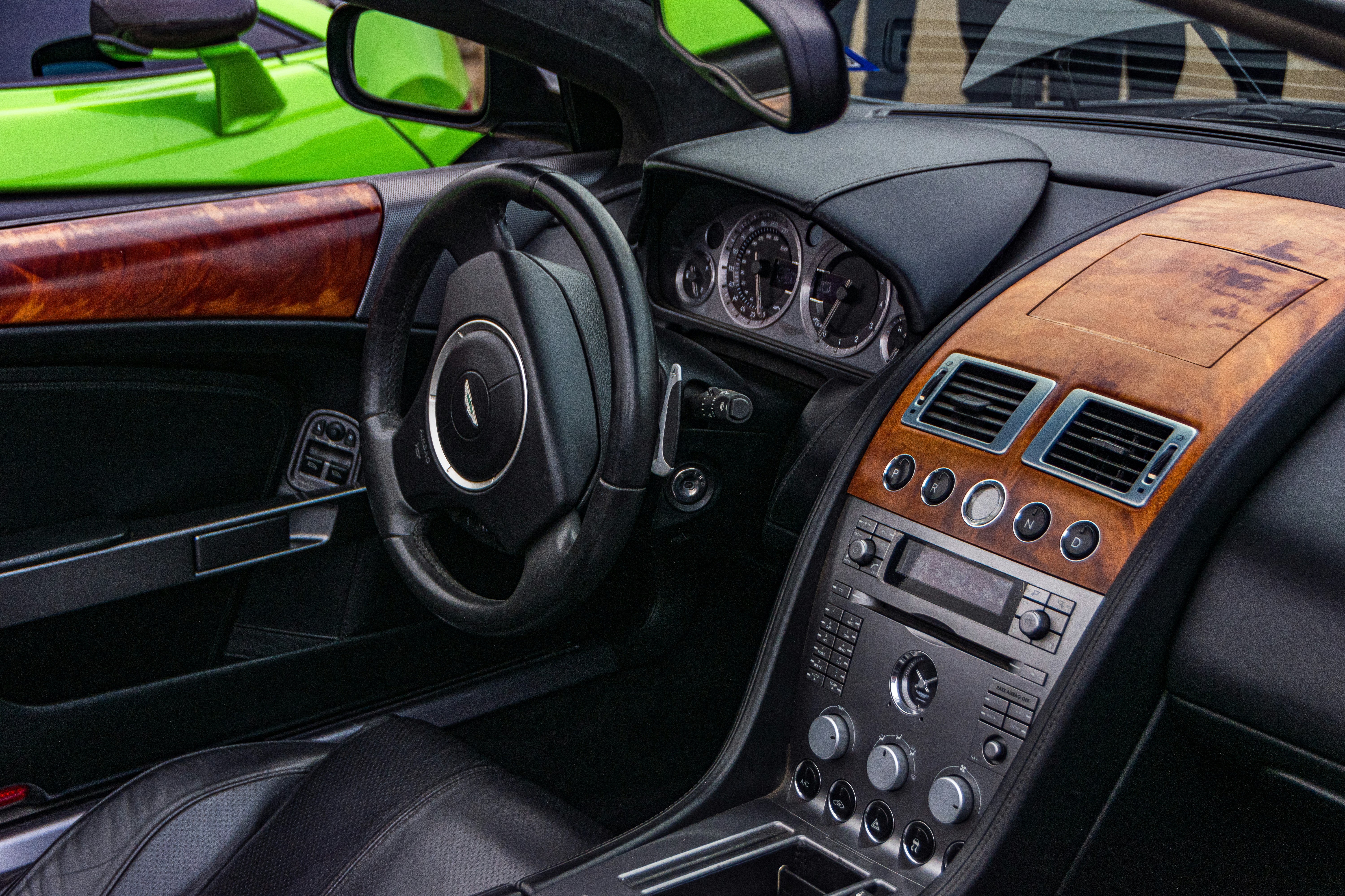 Interior of luxury vehicle with clean leather seats, dashboard gleaming, dim ambient lighting, premium detailing result