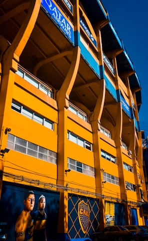 A large yellow building with many windows on it