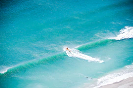 A man riding a wave on top of a surfboard