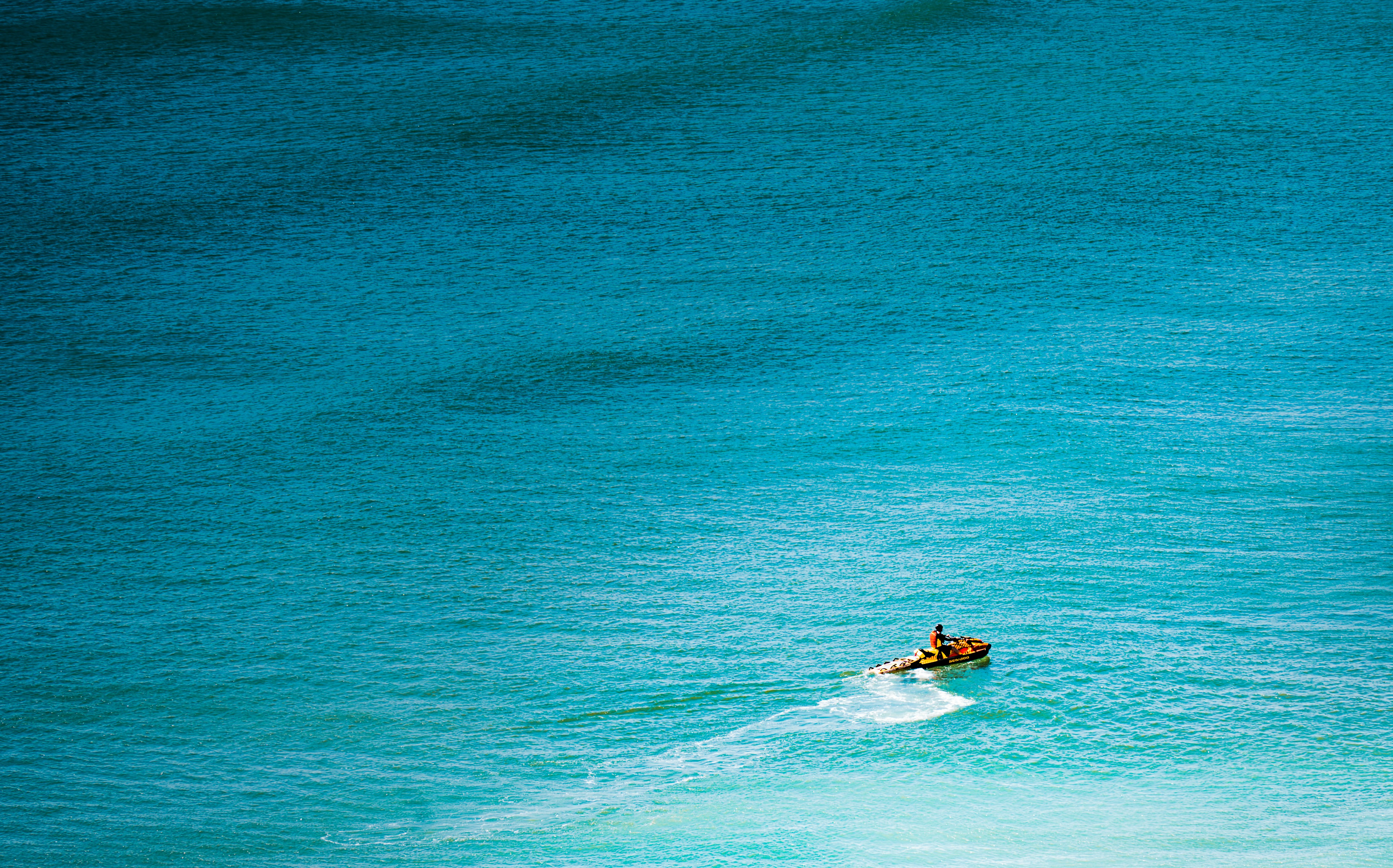 A man riding a wave on top of a surfboard
