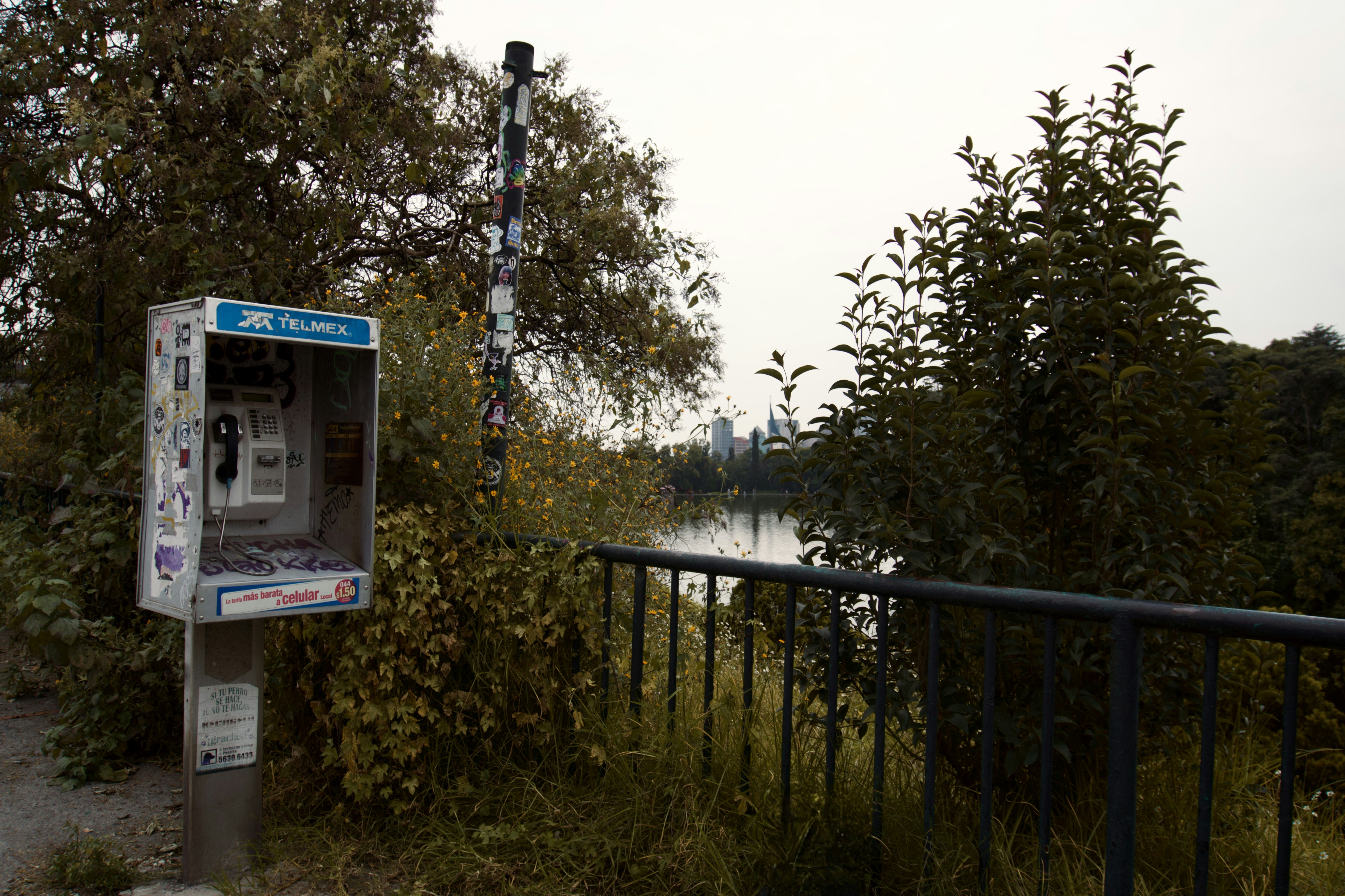 A phone booth sitting on the side of a road