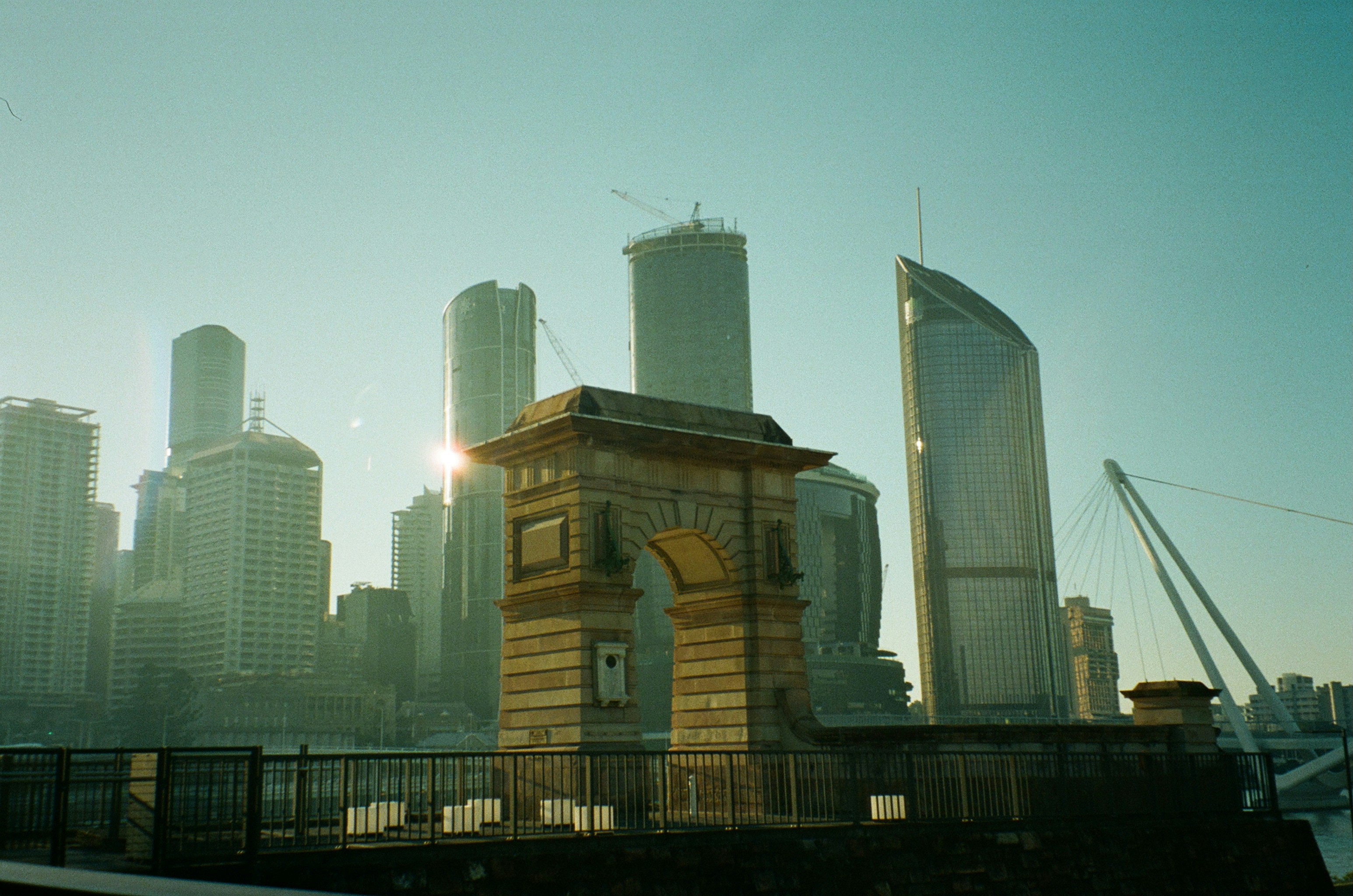 A clock tower in front of a city skyline
