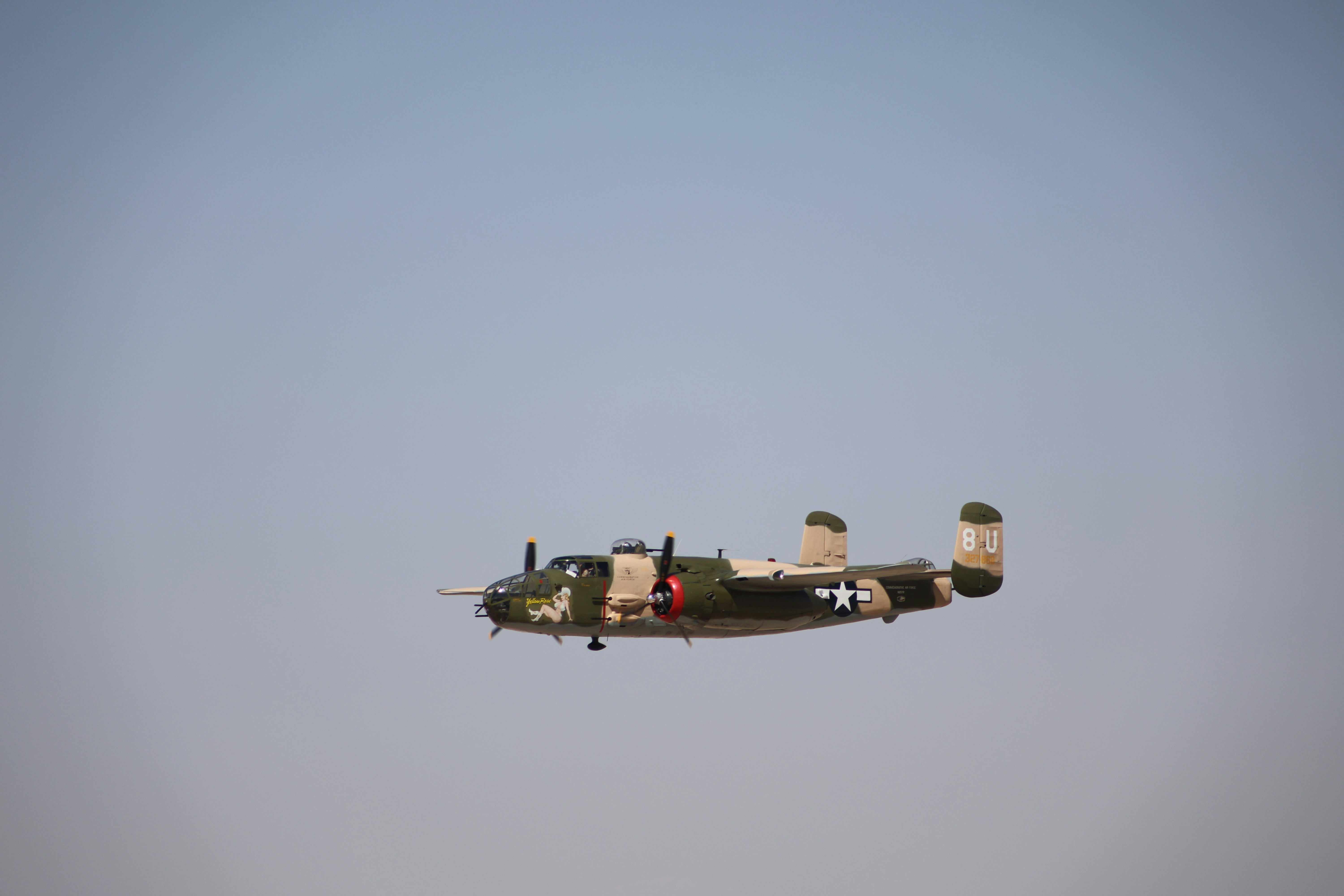 An airplane flying in the air with a sky background, 