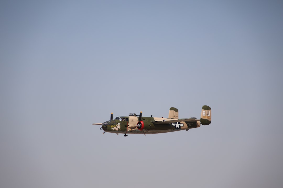 An airplane flying in the air with a sky background,