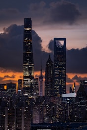 A view of a city at night with clouds in the sky