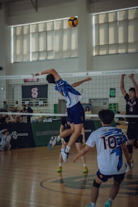A group of young men playing a game of volleyball