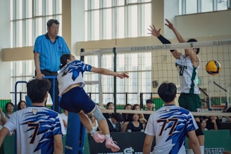 A group of young men playing a game of volleyball