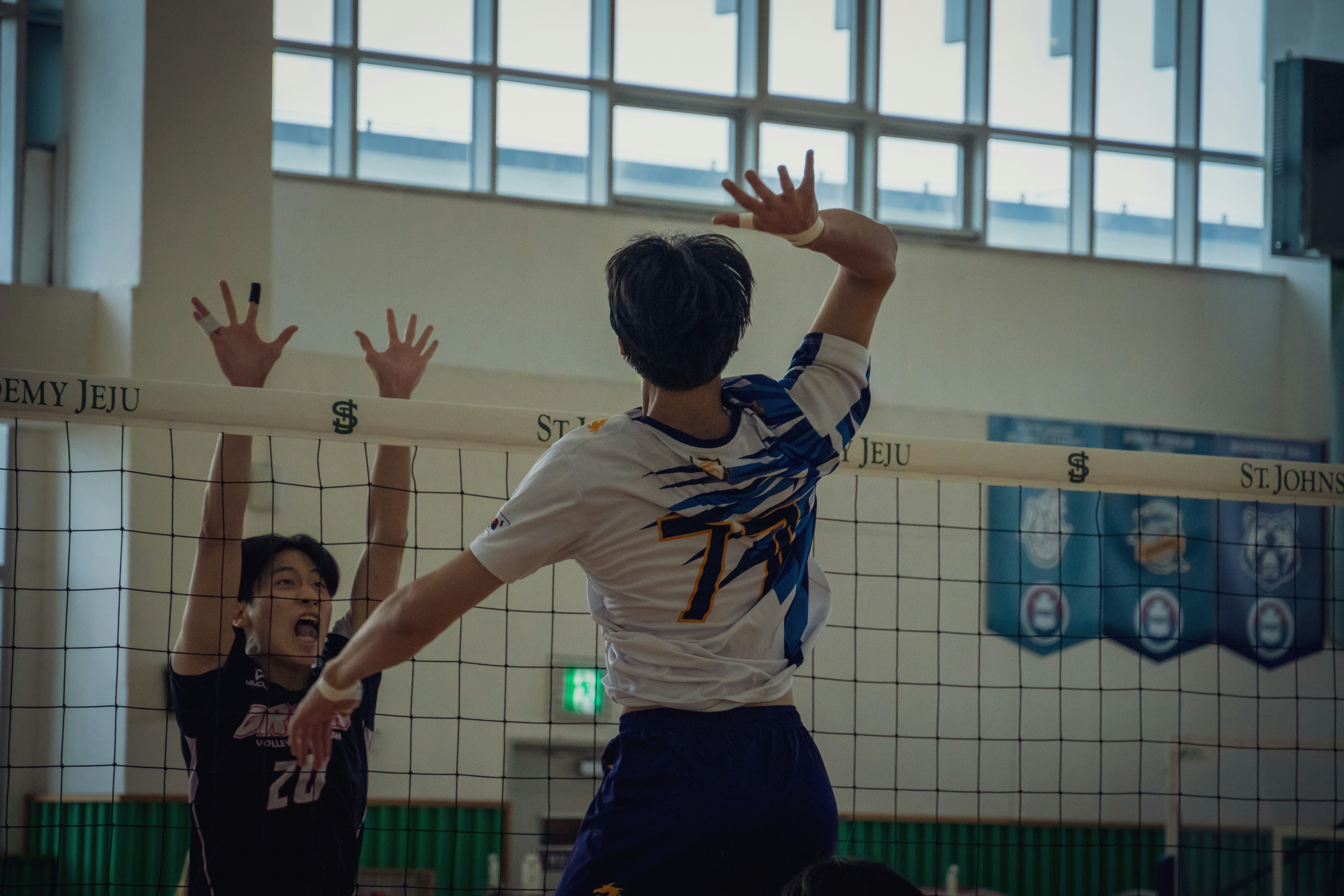 A group of young men playing a game of volleyball