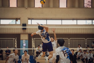 A group of young men playing a game of volleyball