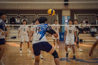 A group of young men playing a game of volleyball