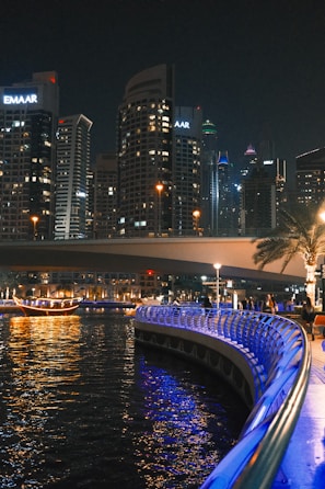 A view of a city at night from the water