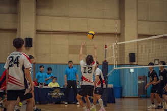 A group of young men playing a game of volleyball