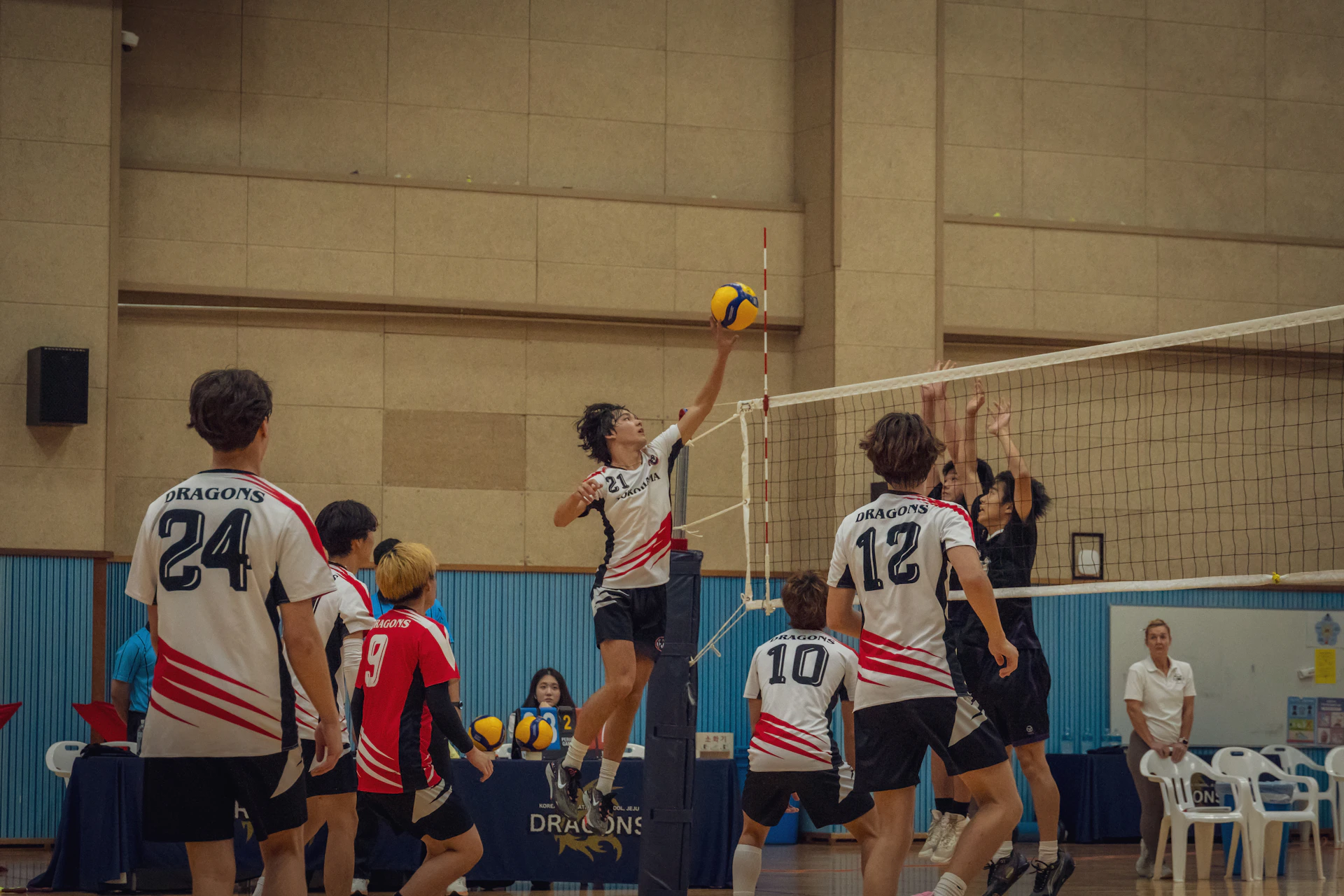 A group of people playing a game of volleyball