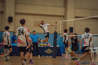 A group of young men playing a game of volleyball