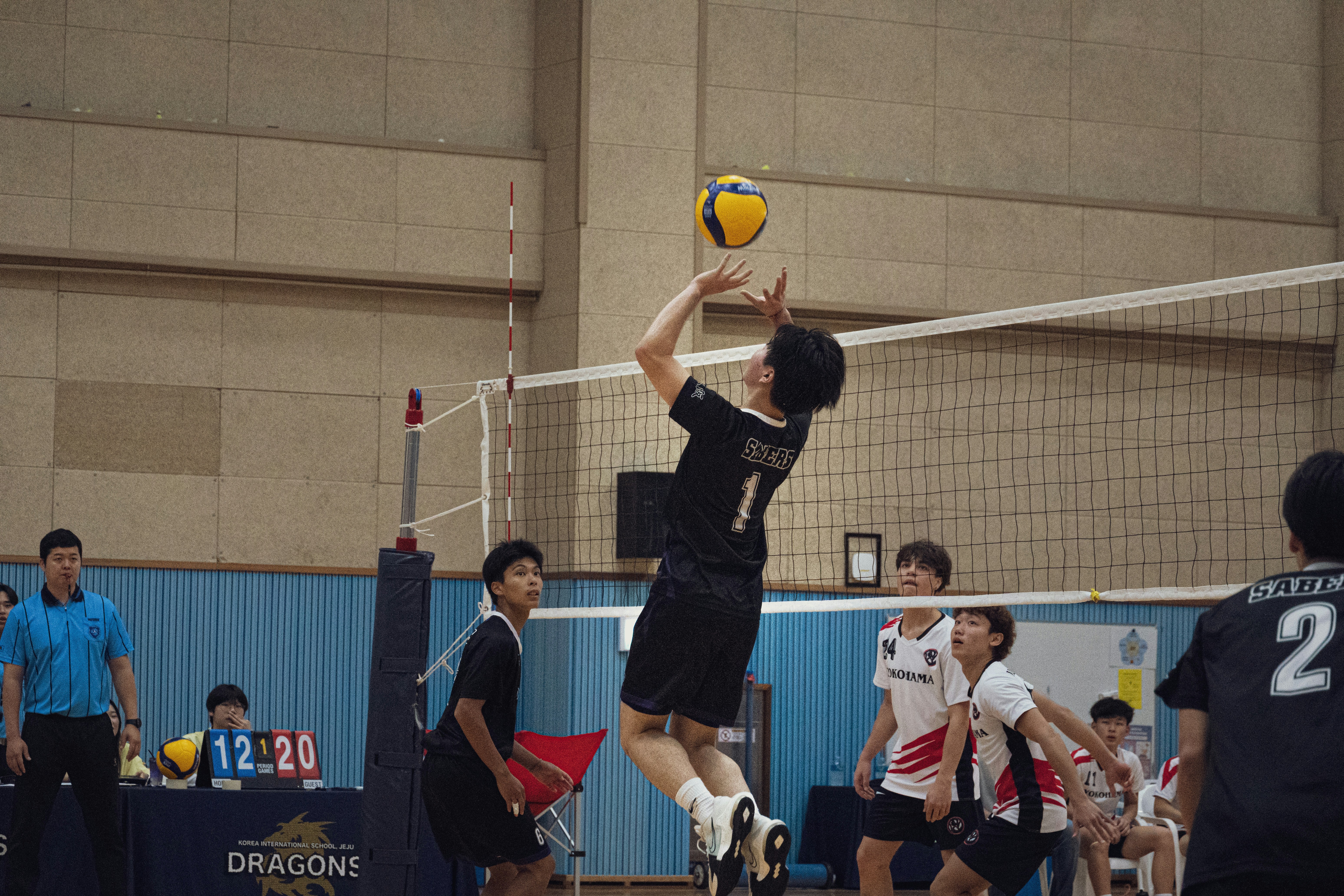 A group of men playing a game of volleyball