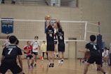 A group of young men playing a game of volleyball
