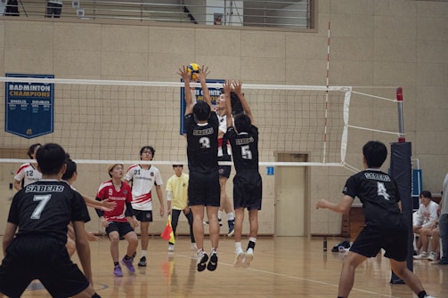 A group of young men playing a game of volleyball