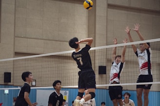 A group of young people playing a game of volleyball