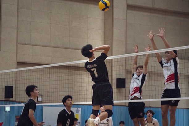 A group of young people playing a game of volleyball