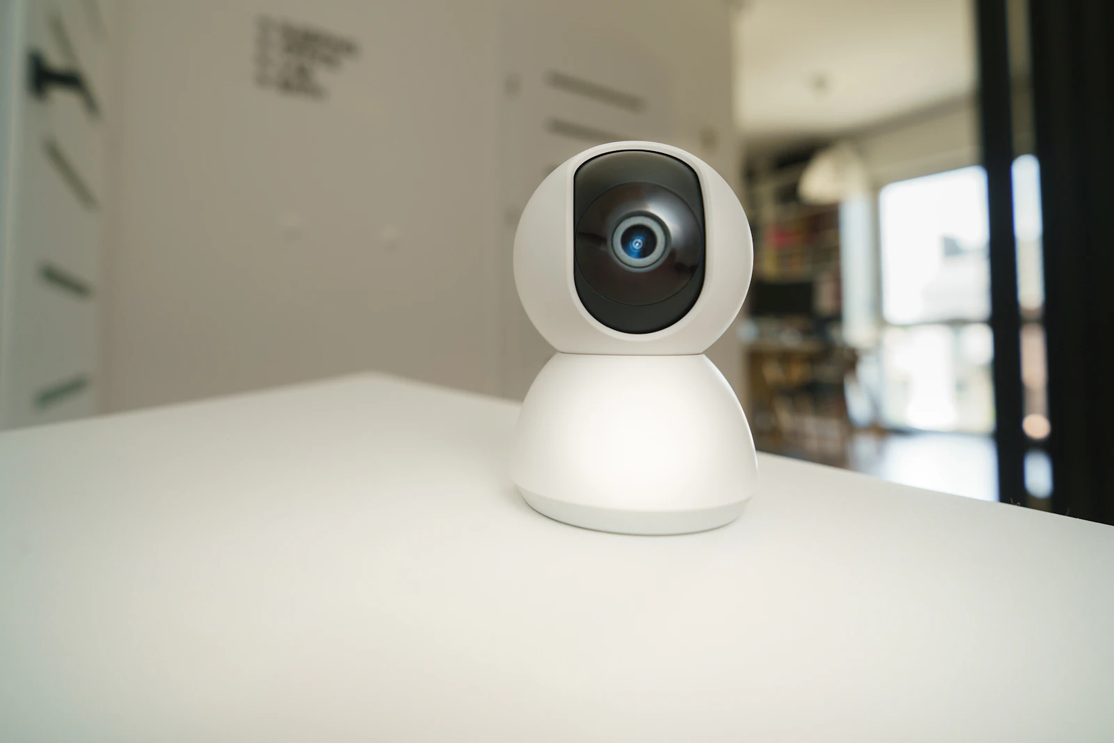 Compact indoor smart security camera on a white surface