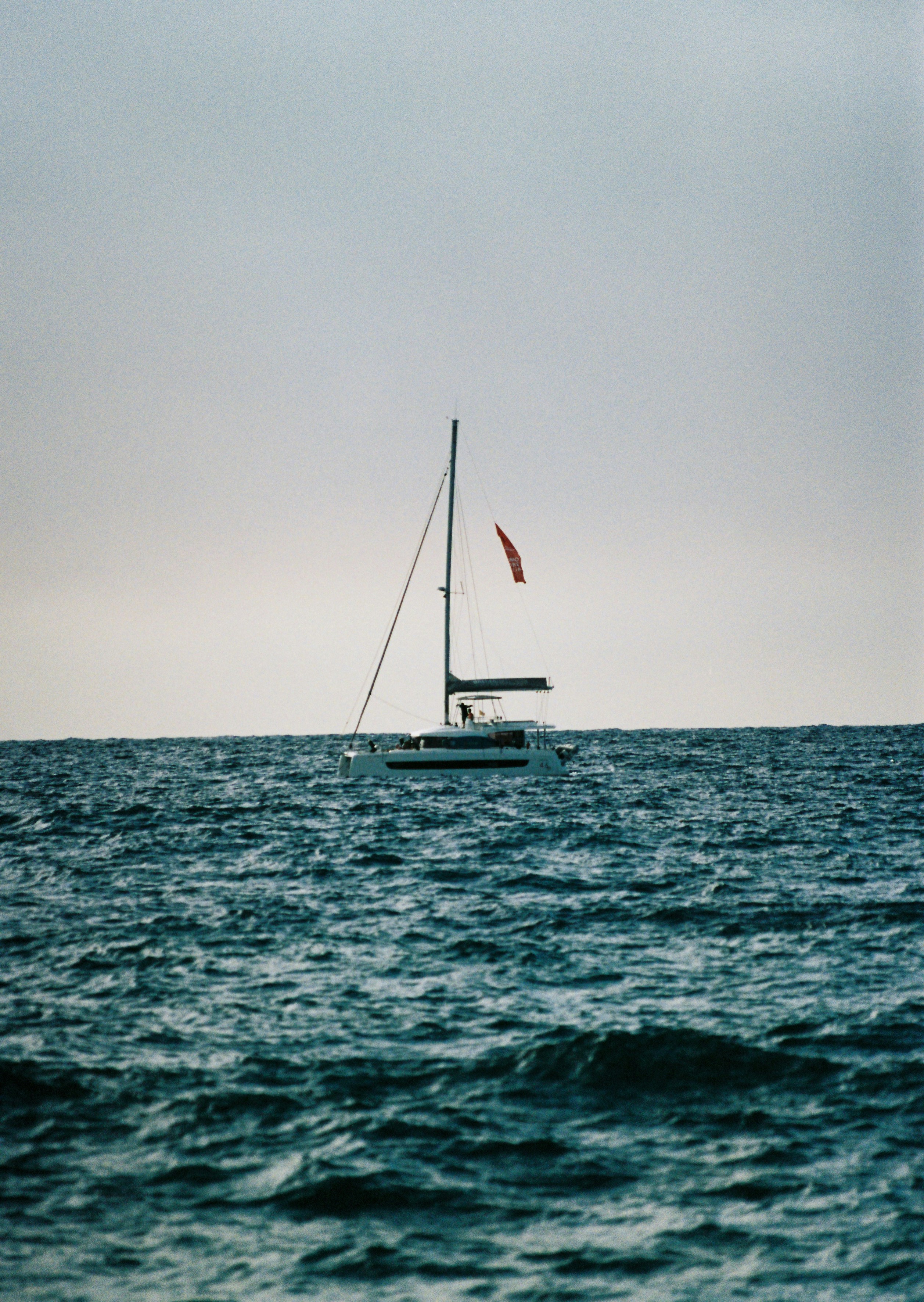 A sailboat in the middle of the ocean