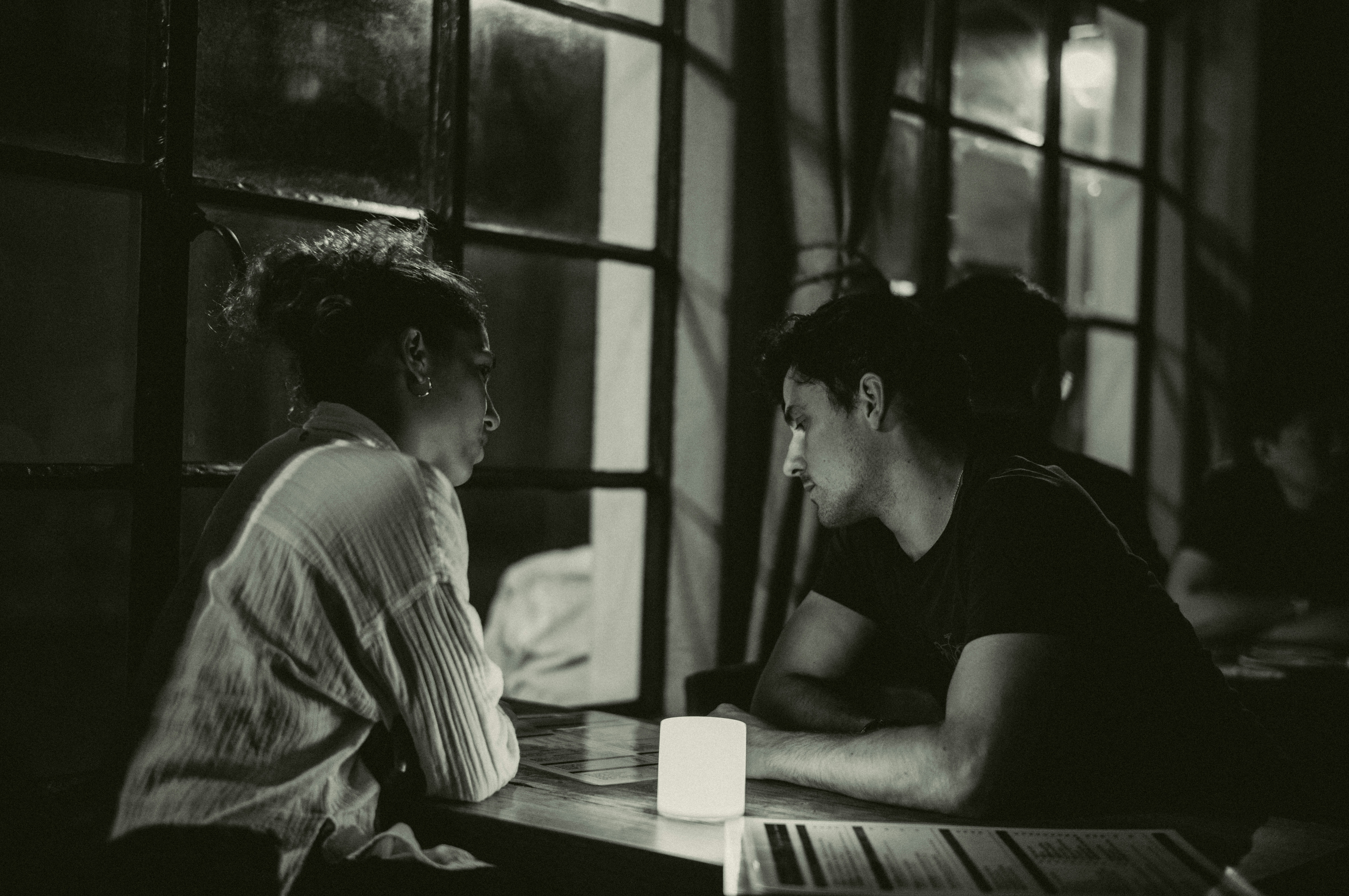 A couple of people sitting at a table, 