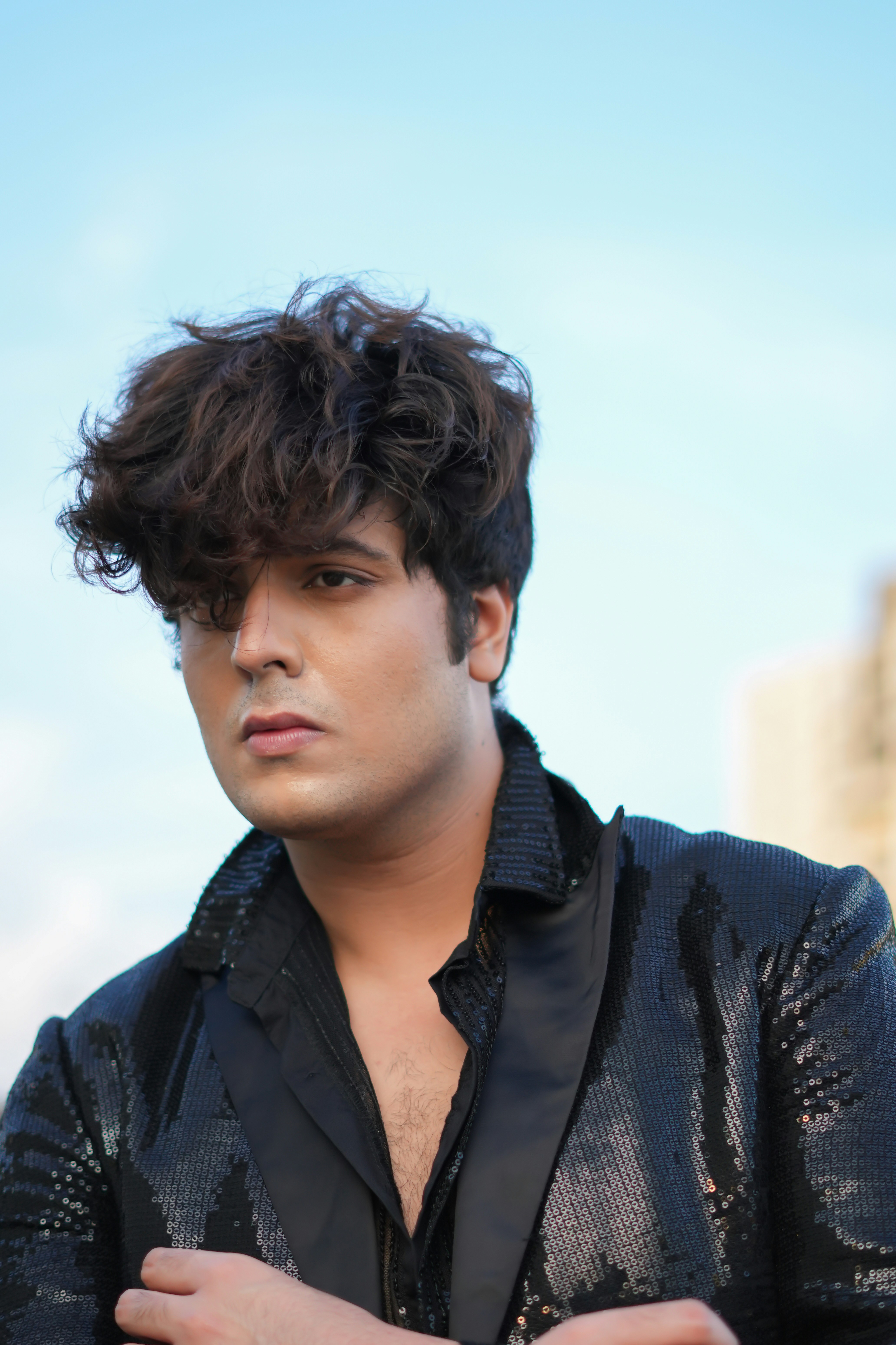 A man in a black shirt and a black jacket