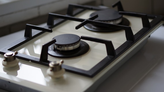 A close up of a stove top with a window in the background