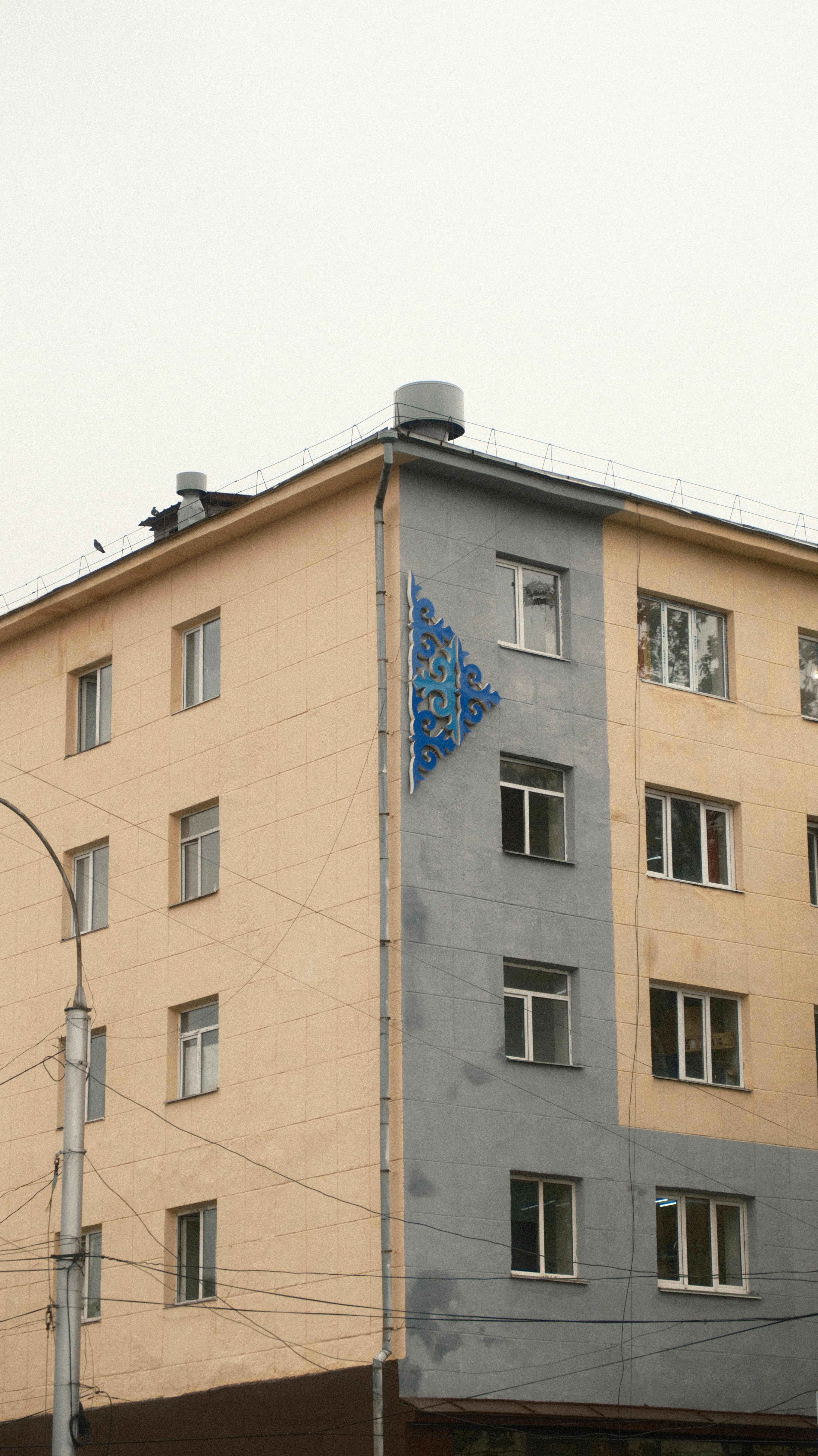 A tall building with a blue triangle on the side of it