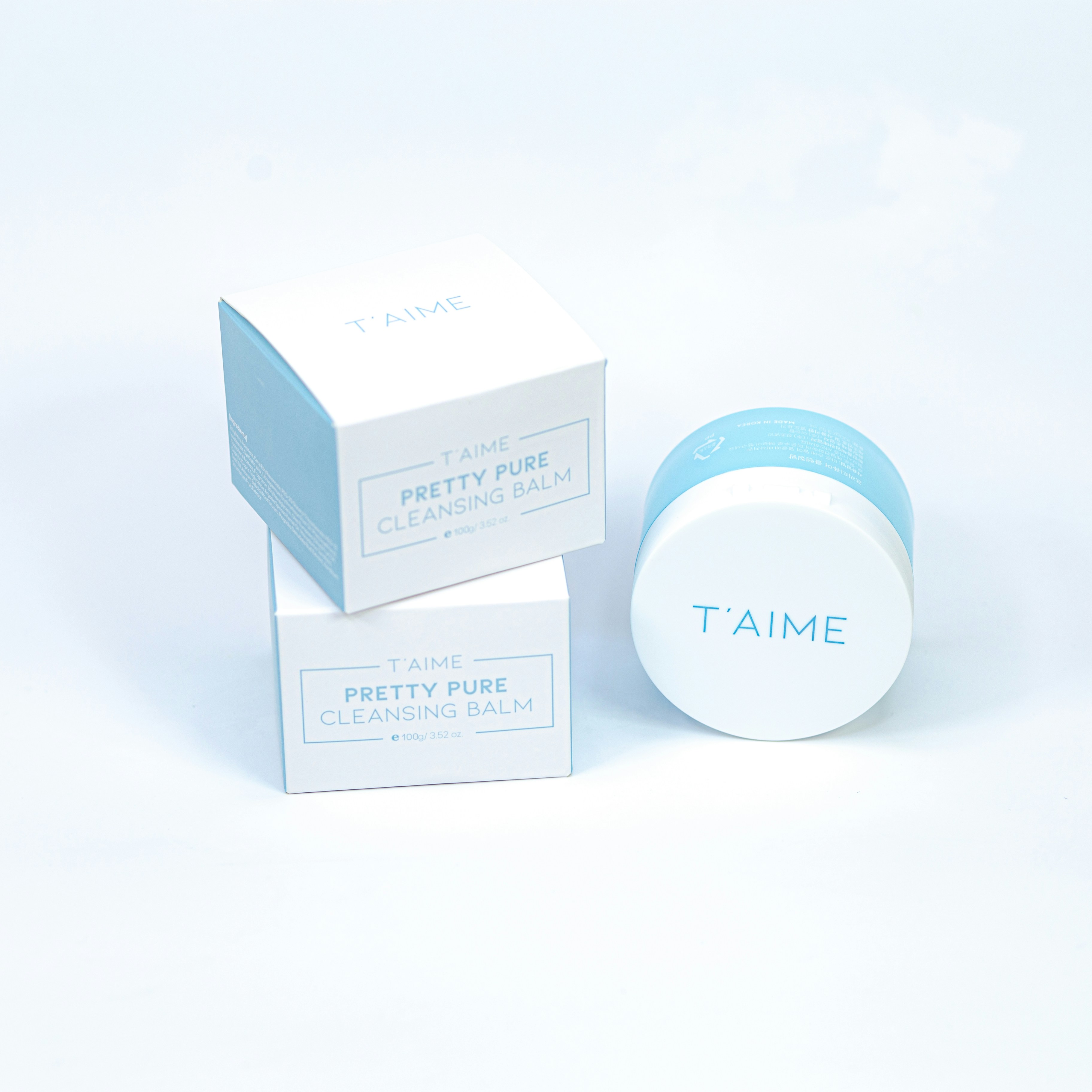 A blue and white container sitting next to a white box