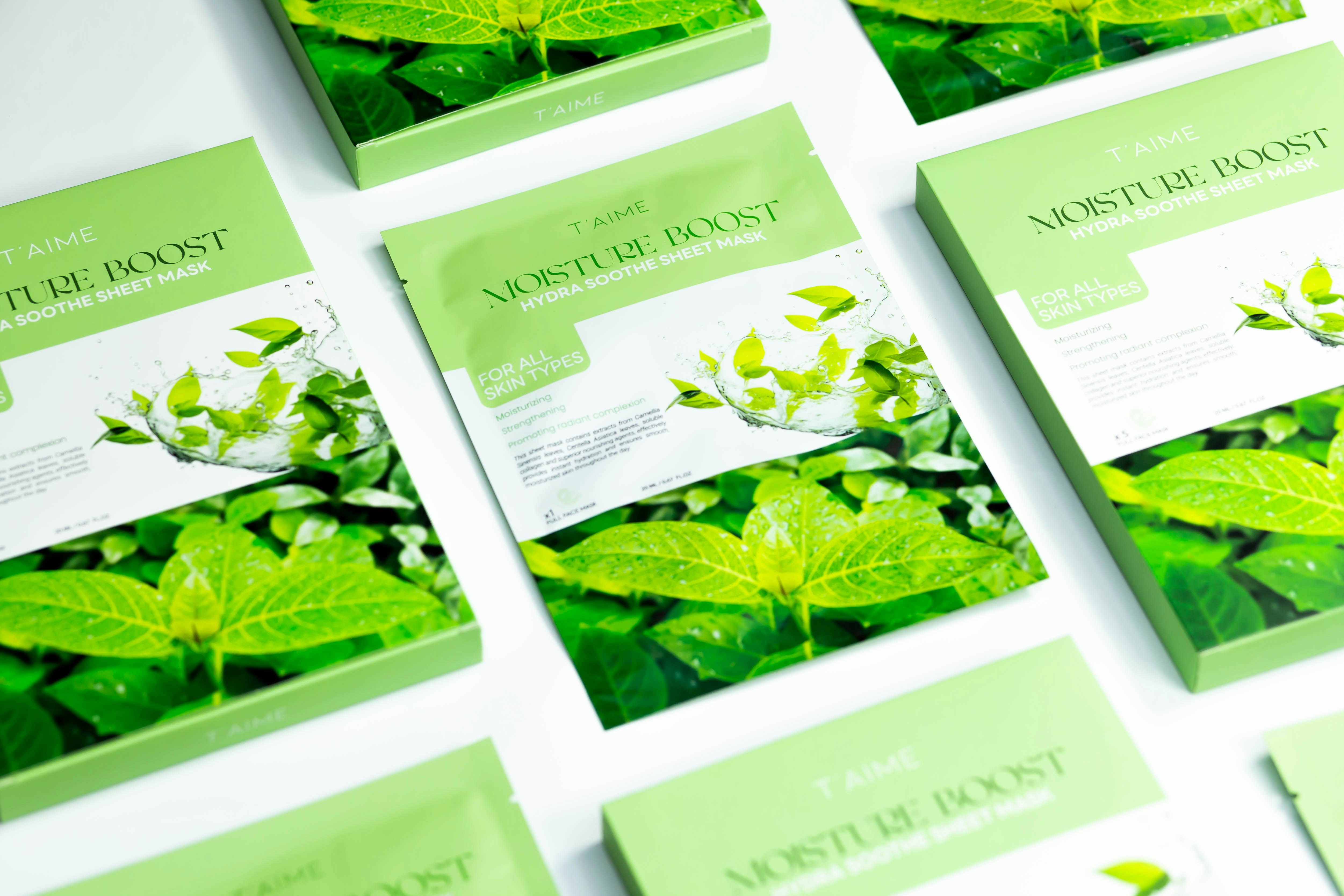 A table topped with lots of cards covered in green leaves