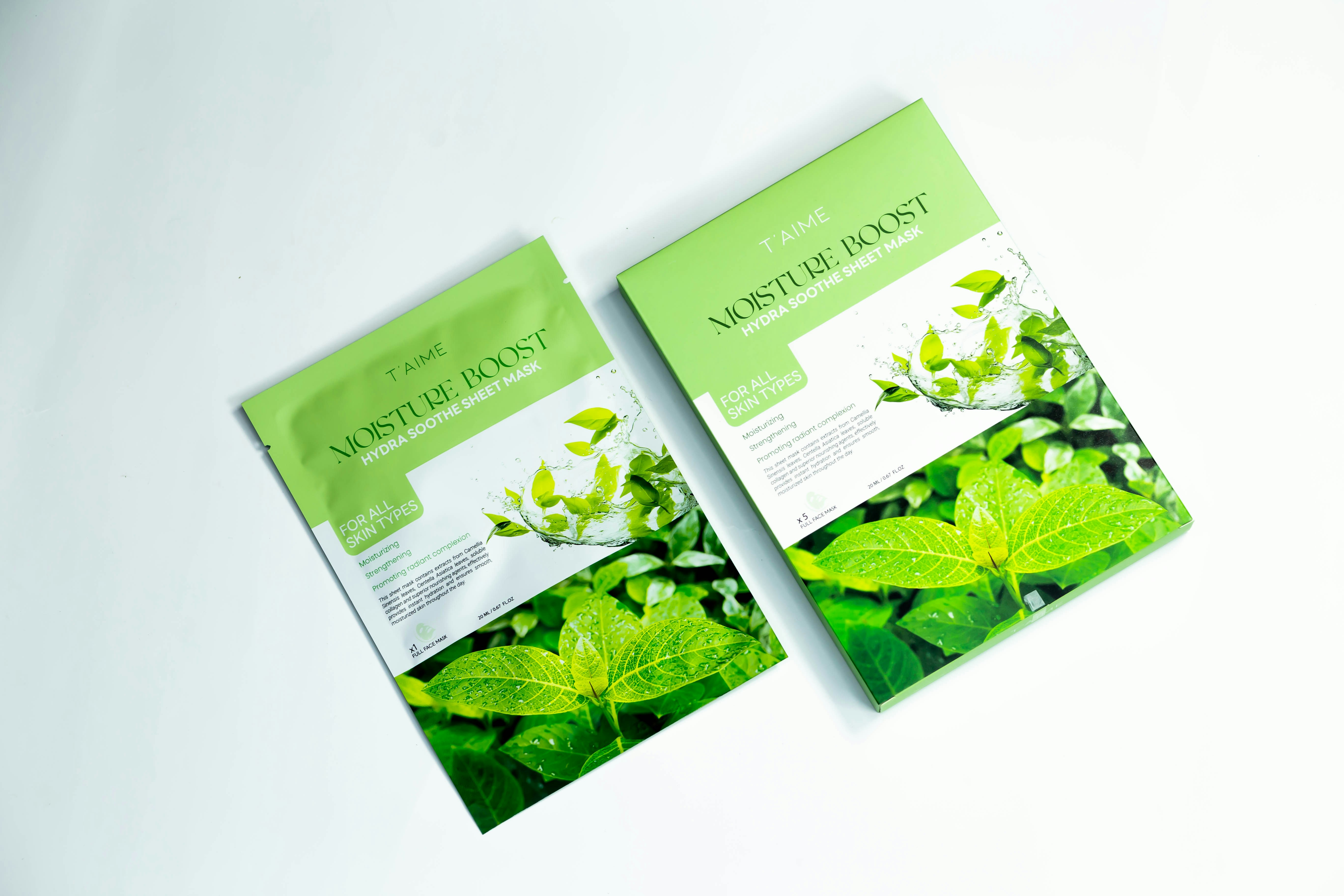 Two packets of green tea sitting on top of a table