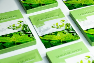 A table topped with lots of cards covered in green leaves