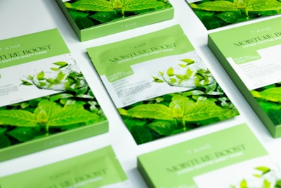 A table topped with lots of cards covered in green leaves