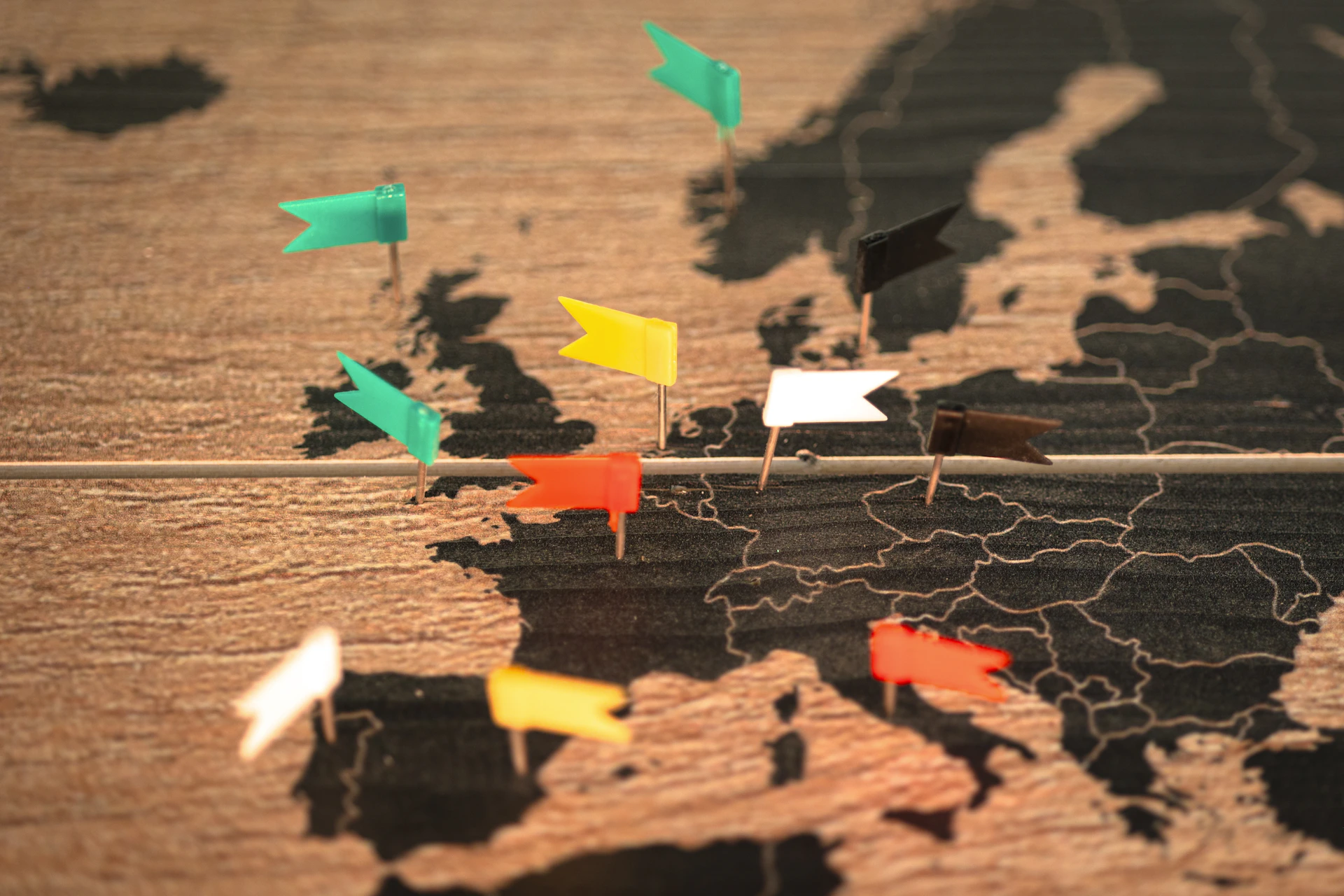 A map of the world with pins pointing in different directions