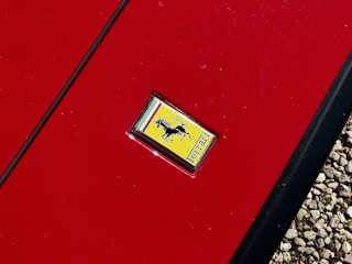 A close up of a red door with a sticker on it