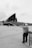 A black and white photo of a man taking a picture