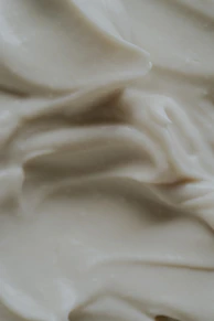 A close up of a white frosted cake