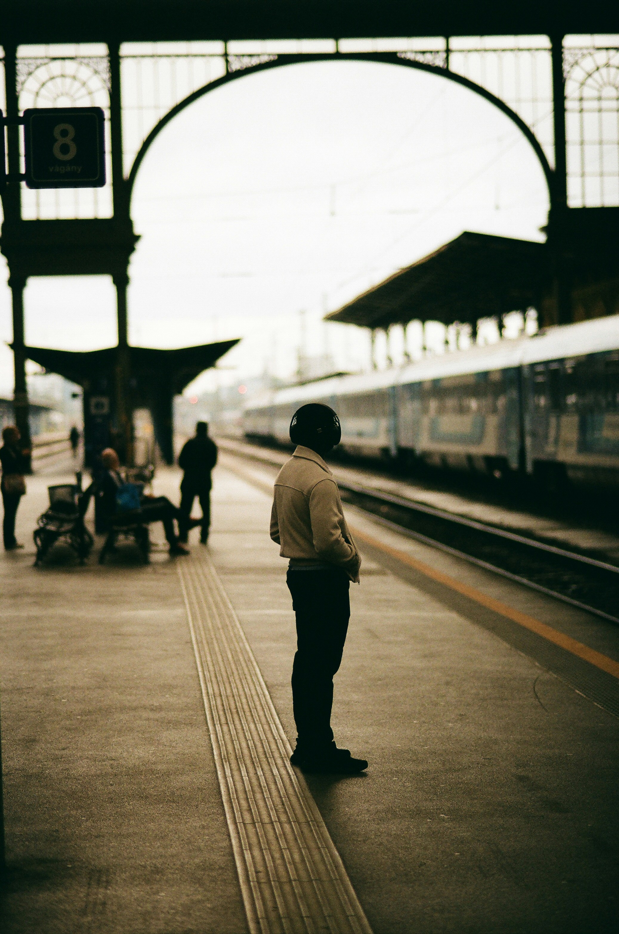 A man waiting for a train at a train station