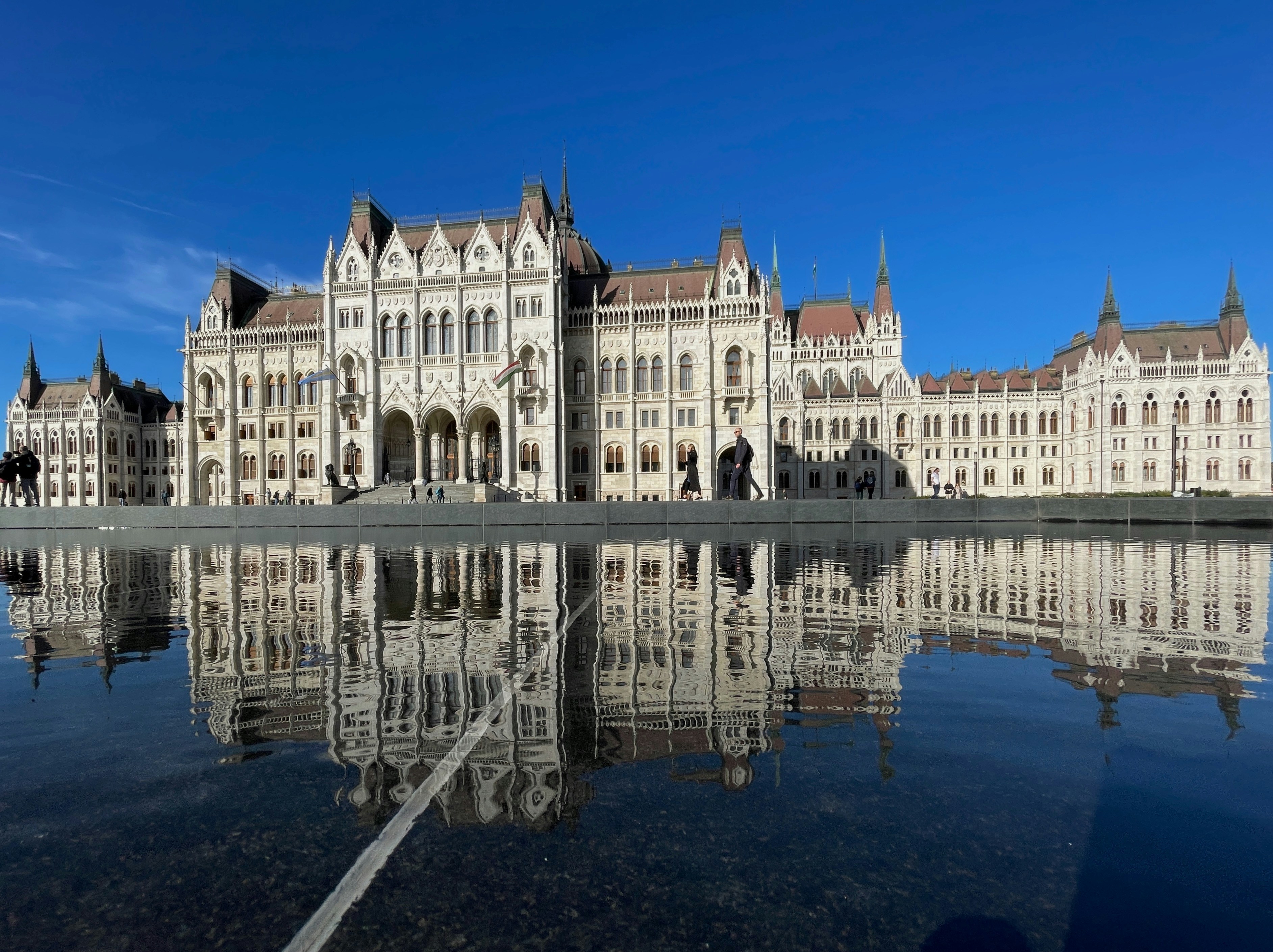 A large building with a large body of water in front of it