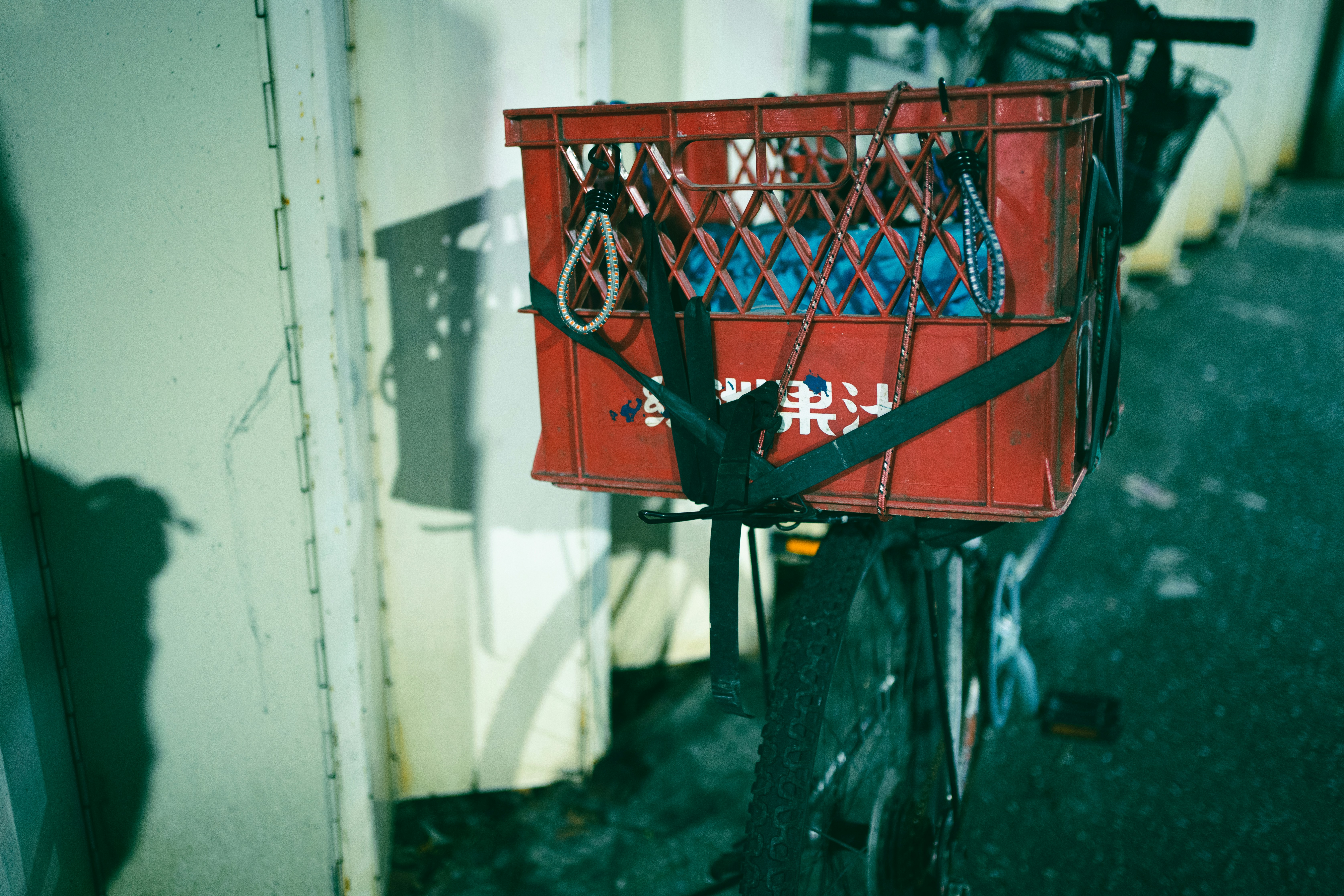 A red bike with a basket on the back of it